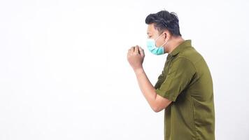 Adult male with face mask coughing intensely due to illness isolated on white background photo