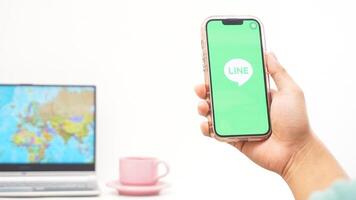 Yogyakarta, Indonesia, 2025 - Man holds smartphone and open LINE social media application isolated on white background photo