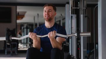 Man in wheelchair doing bicep curls with barbell video