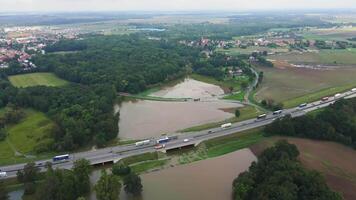 Aerial view of flooded fields and submerged rural road near highway video