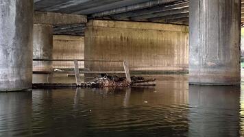 Garbage under the bridge in the middle of the reservoir video