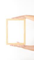 Hand holding thin wood picture frame isolated on white background photo