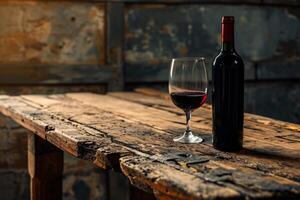 Bottle of red wine and a glass of wine on an old wooden table. Front view with copy space and product space. With copy space for your text. Background design, menu, product advertising. photo