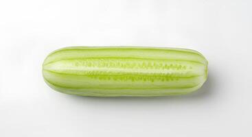 Organic cucumber vegetable isolated on white background with shadow for nutrition and wellness designs. Ripe cucumber on white background for natural skincare, salad recipes and summer freshness theme photo