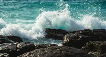Close-up of ocean waves crashing against rocky shoreline during summertime on a sunny day photo