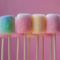 Row of colorful marshmallows on sticks photo