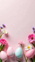 Bright pastel colored Easter eggs adorned with flowers create a vibrant spring atmosphere on a soft pink surface. Social media frame with place for text. Banner card with copy space. photo