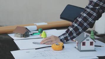 A person is working on a house with a tablet video