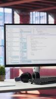Vertical Empty desktop monitor used for software development and coding in a luxurious loft apartment. Modern workstation or in a stylish studio supports tech performance and big data systems. video