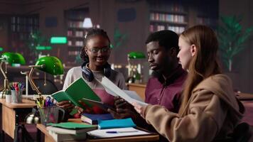 College students collaborating on startup project in the campus library, focusing on international business administration and management. Studying hard for their academic degree. Camera A. video