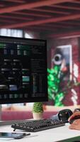 Vertical African american man looks at notes on terminal window for visual programming, typing code on software at his home office. Coding application UI used by engineer writing and testing code. Camera A. video