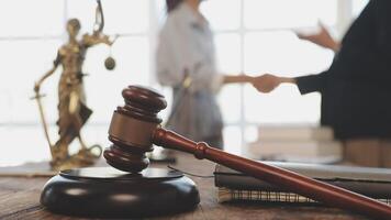 Lawyer and judge shaking hands on desk video