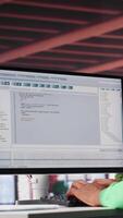 Vertical Tech savvy black engineer developing secure online program at home. Surrounded by binary data, freelancer works on interface design, script optimizations and network systems. Camera A. video