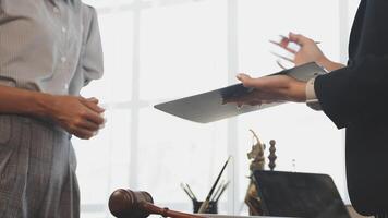 A man in a suit is holding a clipboard while another woman is standing next to him video