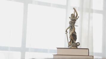 A statue of lady justice on top of books video