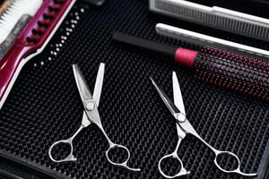 Quality hair scissors and styling tools arranged on a salon table photo