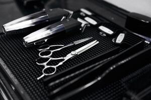 Professional barber tools neatly arranged on a work surface in a salon photo