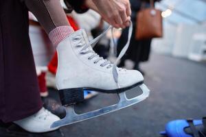 Skater prepares for a session on ice during winter festivities in a rink photo