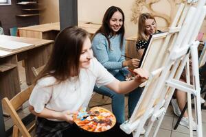 Artistic workshop with students painting and learning in a cozy studio photo