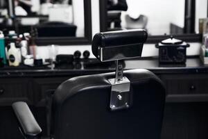 Black barber chair in a stylish salon with modern decor and tools photo