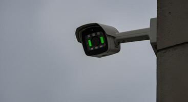 Surveillance camera mounted on building corner, offering enhanced security photo