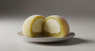 Delicious halved mochi with a sweet cream filling isolated on soft gray background photo