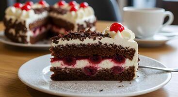 A slice of black forest gateau cake with a cherry on top delightful treat photo
