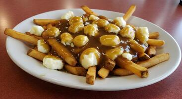 Delicious Canadian Poutine featuring golden fries, gravy and cheese curds photo