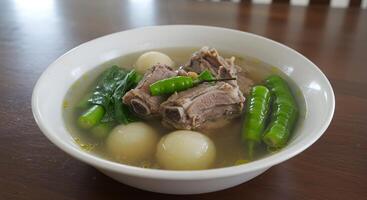 Delicious Sinigang Soup Featuring Tender Ribs and Fresh Green Vegetables photo