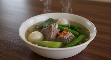 Delicious and comforting filipino pork rib stew with vegetables in a bowl photo