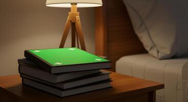 Stack of books on a nightstand with a green screen book on top for mockups photo