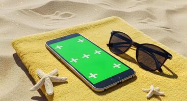 Modern smartphone with chroma key screen on a yellow towel at sandy beach photo