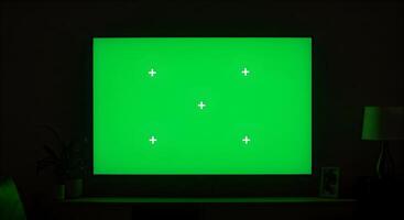 Television screen with chroma key for customization in a darkened room photo