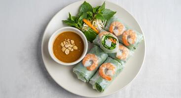 Delectable shrimp spring rolls with peanut dipping sauce culinary delight photo