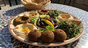 Exquisite selection of Middle Eastern dips and appetizers, inviting and vibrant photo