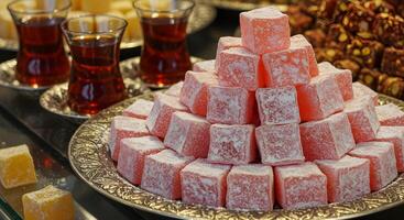 Delicate Turkish Delight Pyramid with Traditional Tea Service on Display photo