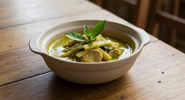 Delicious Thai Green Curry Served in Ceramic Bowl on Wooden Table Top photo