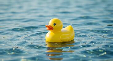 Tranquil scene of a vibrant yellow rubber duck peacefully floating on rippling water photo
