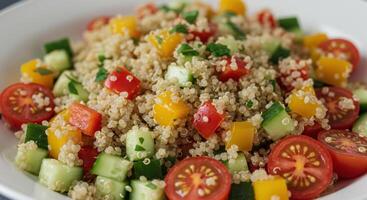 A delightful quinoa salad featuring an array of fresh, colorful vegetables, perfect for a healthy meal. photo