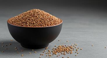 A beautiful black bowl overflows with nutritious grains, creating a visually appealing scene. photo