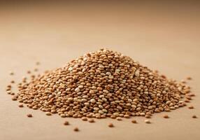 A large mound of quinoa, a nutritious and delicious grain, sits against a brown backdrop. photo