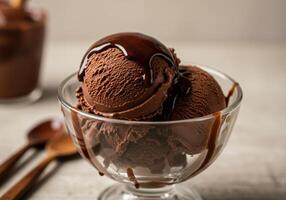 A beautiful dessert consisting of scoops of chocolate ice cream with sauce. photo