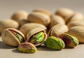Fresh pistachios in a close up view, with some nuts shelled and ready to eat. . photo