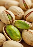 A close-up view of fresh pistachios, with some nuts shelled, ready to eat. photo