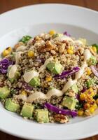 A colorful and nutritious quinoa salad with fresh avocado, corn, and walnuts. photo