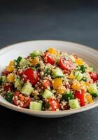 A colorful and nutritious quinoa salad, filled with fresh vegetables, perfect for a healthy meal. photo