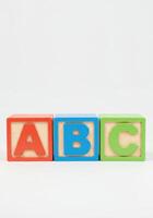Three vibrant blocks, displaying letters A, B, and C, form an elementary learning tool. photo