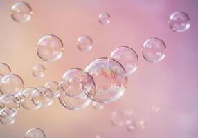 A cluster of transparent soap bubbles float gently against a soft gradient backdrop. photo
