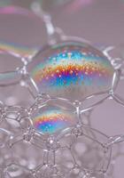 Vibrant macro photograph of a soap bubble displaying mesmerizing, rainbow-like colors. photo