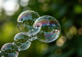 Beautiful bubbles floating with colorful reflections against a soft green background. photo